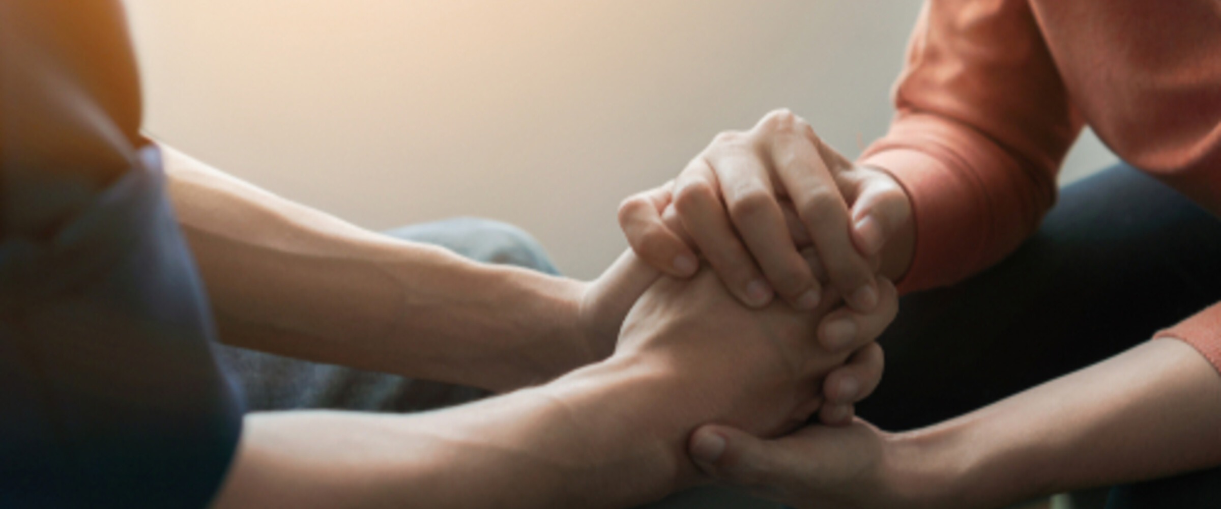 two people holding hands in a supportive way